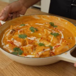 Tofu Butter Masala Recipe served in a bowl with creamy masala gravy and garnished with soy cream and coriander leaves