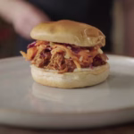 Pulled BBQ jackfruit pulled pork recipe served in a bun, topped with Cajun mustard slaw
