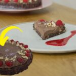 Make Chocolate Hazelnut Cake topped with toasted hazelnuts